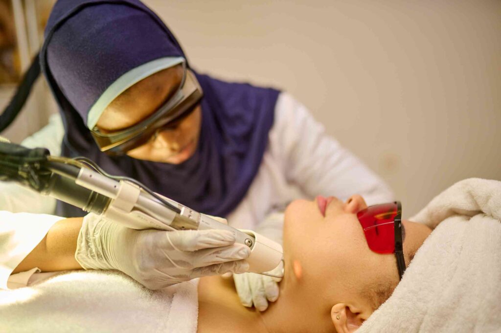 A picture of a Dermatologist doing a Laser hair removal for a client's Underchin